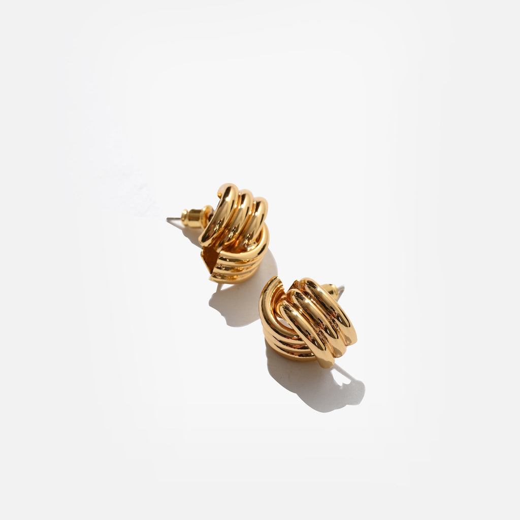 Gold earrings on a white background