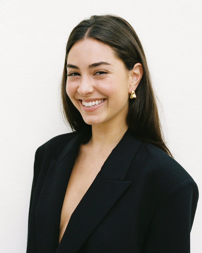 Woman wearing a black blazer against a white background