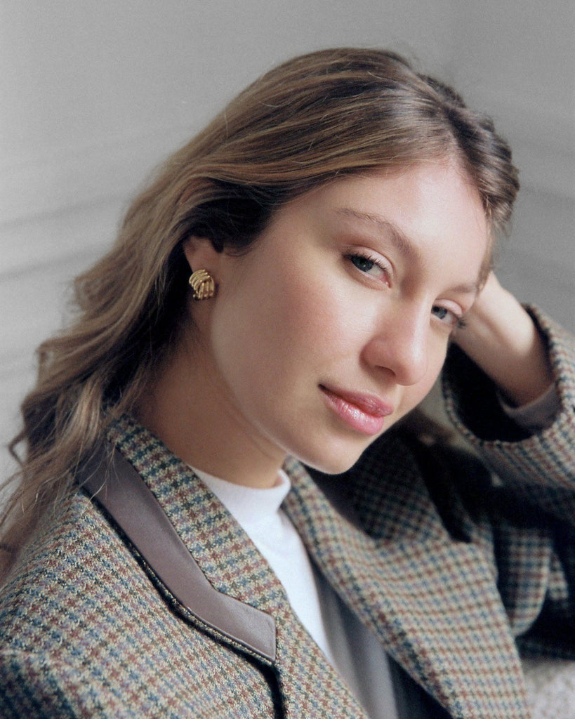 Woman wearing a patterned coat with a neutral background